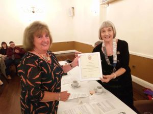 Ann Gent receives her award from Pat De Martino